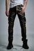 Distressed leather biker pants with quilted knee padding. Modern cut and slim fit. Unique piece, hand-finished using FRANCUIR's exclusive corrosive artisanal process.