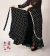 Falda flamenca Envolvente Cruzada de Seda Negra Lunares Blancos y Puntilla Broderie - comprar online
