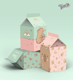 Cajas tipo milk box de cartón imprimibles con ilustraciones de capybaras y elementos festivos en colores pastel.