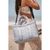 Tote bag celeste con asas, ideal para uso diario, llevada por una modelo en la playa.