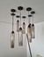 Lustre pendente Dunáh de vidro fumê instalado em sala de jantar moderna. Lustres Gênesis loja online de Lustres e Iluminação Decorativa