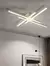 Luminária Plafon 100cm Preto Hash instalada no teto, com design moderno e linhas cruzadas, iluminando sala de estar. Lustres Gênesis Site online venda de Lustres e Iluminação