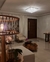 Lustre Plafon de Cristal Harion Quadrado iluminando uma sala de estar elegante. Lustres Gêneiss loja online de Lustres e Iluminação Decorativa