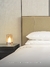 Luminária Vela Contemporânea da Lustres Gênesis ao lado de uma cama em um quarto moderno. Lustres Gênesis Site online venda de Lustres e Iluminação