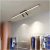 Plafon Moderno Fit Linear Preto instalado em closet moderno com roupas expostas Lustres Gênesis Site online venda de Lustres e Iluminação Decorativa