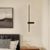 Arandela Moderna Fit Linear Slim de LED Dourada instalada em um quarto ao lado de uma cama.