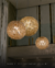 Lustre Pendente de Cristal Dente de Leão Esfera Ø80 em uma sala de estar moderna com pé direito duplo. Lustres Gênesis loja online de Lustres e Iluminação Decorativa