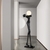 Escultura Equilibrista Preta com Globo Fosco em um hall de entrada moderno. Lustres Genesis loja online de Lustres e Iluminação Decorativa
