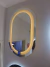 Espelho Moderno Touch Screen Oval 75x50 com LED Luz Direta da marca Reduna instalado em parede. Lustres Genesis loja online de Lustres e Iluminação Decorativa