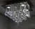 Lustre de cristal em formato de pirâmide com detalhes brilhantes, ideal para sala de estar ou hall de entrada. Lustres Gênesis loja online de Lustres e Iluminação Decorativa