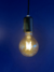 Lâmpada de Filamento de Led G80 4W Squirrel Cage acesa contra fundo azul Lustres Gênesis loja online de Lustres e Iluminação Decorativa