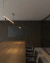 Lustre Pendente Moderno Risk Linear com Spot iluminando uma mesa de jantar em um ambiente sofisticado. Lustres Gênesis Site online venda de Lustres e Iluminação