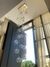 Lustre Pendente Sarvah com 21 globos transparentes em ambiente com pé direito alto Lustres Gênesis loja online de Lustres e Iluminação Decorativa