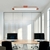 Luminária Plafon Moderno Opus instalada em um escritório moderno com mesas de madeira e computadores. Arandela Moderno Botton de LED Dourada da SkyLight, modelo SKY-3111AR-DO, com design circular e detalhes texturizados. Lustres Gênesis Site online venda 