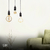 Lâmpadas de filamento de LED em design espiral penduradas em uma sala de estar moderna. Lustres Gênesis loja online de Lustres e Iluminação Decorativa
