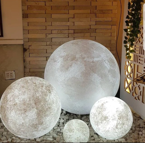 Luminária de chão em formato de lua com diâmetro de 120cm para áreas internas e externas, exibida em ambiente decorativo. Lustres Gênesis loja online de Lustres e Iluminação Decorativa
