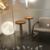 Luminária de Chão Esfera Lua Moon ao lado de móveis de design moderno em ambiente interno. Lustres Gênesis loja online de Lustres e Iluminação Decorativa