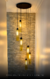 Lustre Pendente Dunáh Moderno com 6 tubos âmbar em ambiente com pé direito alto. Lustres Gênesis loja online de Lustres e Iluminação Decorativa