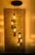 Lustre pendente Dunáh moderno com 6 tubos de vidro fumê, ideal para escadas e ambientes com pé direito duplo ou alto. Lustres Gênesis loja online de Lustres e Iluminação Decorativa