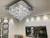 Lustre Plafon de cristal Pirâmide 55x55 instalado em sala moderna com decoração elegante Lustres Gênesis loja online de Lustres e Iluminação Decorativa. 