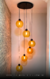 Lustre pendente moderno com 6 globos âmbar, ideal para escadas e ambientes de pé direito duplo. Lustres Gênesis loja online de Lustres e Iluminação Decorativa