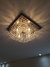 Lustre de Cristal Zecor Quadrado iluminando um ambiente interno Lustres Gênesis loja online de Lustres e Iluminação Decorativa