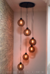 Lustre pendente Sarvah moderno com 6 globos fumê, ideal para escadas e ambientes com pé direito alto. Lustres Gênesis loja online de Lustres e Iluminação Decorativa