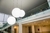 Luminária de teto pendente em formato de esfera branca instalada em um ambiente com escadas e pé direito duplo. Lustres Gênesis loja online de Lustres e Iluminação Decorativa