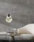 Pendente Moderno de LED Blackmoon instalado em ambiente elegante com parede cinza e móveis sofisticados. Lustres Gênesis loja online de Lustres e Iluminação Decorativa