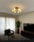 Plafon Espiral Jabuticaba com 9 globos iluminando uma sala de estar moderna. Lustres Gêneis loja online de Lustres e Iluminação Decorativa