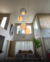 Lustre pendente grande com 3 esferas de mármore suspensas em uma sala com pé direito duplo. Lustres Gênesis Site online venda de Lustres e Iluminação