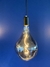 Lâmpada de Filamento de Led PS53 Fumê 4W Soft pendurada com fundo azul Lustres Gênesis loja online de Lustres e Iluminação Decorativa