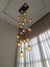 Lustre Pendente Sarvah com 18 globos fumê em um ambiente com pé direito duplo Lustres Gênesis loja online de Lustres e Iluminação Decorativa