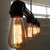 Lâmpadas de filamento de carbono vintage ST64 iluminadas em um suporte industrial. Lustres Gênesis loja online de Lustres e Iluminação Decorativa