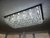 Lustre de Cristal Retangular Zecor 60x30 instalado em um teto, iluminando uma sala de jantar ou estar. Lustres Gênesis loja online de Lustres e Iluminação Decorativa. 