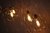 Lustre Pendente Sarvah com globos âmbar iluminados, ideal para ambientes com pé direito duplo ou alto. Lustres Gênesis loja online de Lustres e Iluminação Decorativa. 