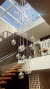 Lustre Pendente Sarvah com 36 globos transparentes em uma escada interna moderna. Lustres Gênesis loja online de Lustres e Iluminação Decorativa. 