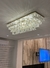 Lustre de Cristal Maia 120x40 Retangular iluminando uma sala de jantar moderna. Lustres Gêneiss loja online de Lustres e Iluminação Decorativa