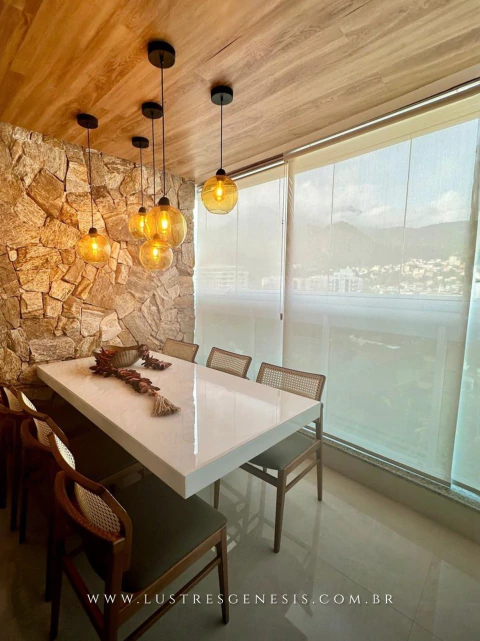 Lustre pendente Sarvah de vidro âmbar iluminando mesa de jantar moderna em ambiente decorado com parede de pedra. Lustres Gêneiss loja online de Lustres e Iluminação Decorativa