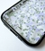 Funda para iPhone 15 Pro Max con diseño floral en tonos lilas sobre fondo transparente.