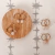 Aros CLARK - Acero dorado + Cuarzo Rosa - comprar online