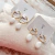 Aros CLARK - Acero dorado + Onix Blanco - comprar online