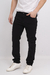Pantalón regular de color negro, con un corte ajustado y un diseño clásico, combinado con una camiseta blanca y zapatillas blancas.