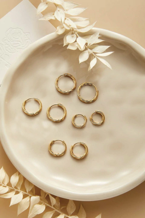 Argollas torzadas clicker de acero dorado (par)