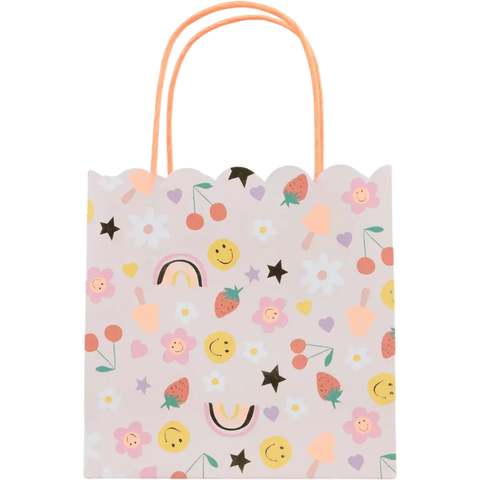 Sacolinha surpresa Happy Icons da Meri Meri com estampas coloridas de flores, estrelas, arco-íris, morangos e carinhas sorridentes, ideal para festas infantis.