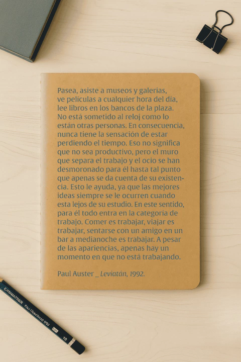 Cuaderno Auster Kraft tamaño A5 con texto impreso en tapa sobre productividad y ocio, acompañado de un lápiz negro y un clip sujetapapeles sobre una mesa clara