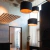Colgante ROMA 38 en un ambiente moderno con tres lámparas cilíndricas negras y un diseño elegante. con aislante acustico