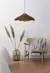 Lámpara colgante modelo LOMBOK XL en madera, suspendida sobre una silla de diseño minimalista, junto a un jarrón con pampas.