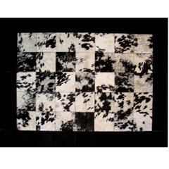 BORDERED BLACK SPLASHED COWHIDE RUG - CALMA CHICHA