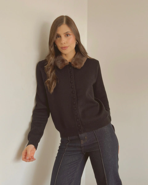 Vista frontal del buzo de punto negro P.102 combinado con jeans oscuros.